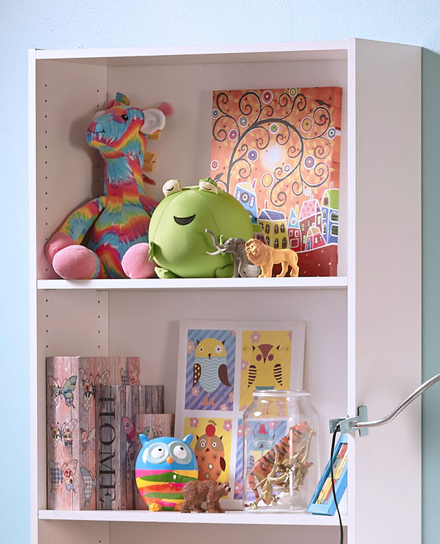 Detalle de estante blanco con muñecos, peluches y decoración infantil.