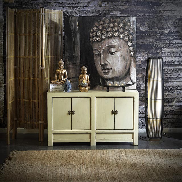 Mueble estilo Zen con figuritas de Buda y lienzo de Buda. A uno de los costados un biombo de bambú natural. Homy.